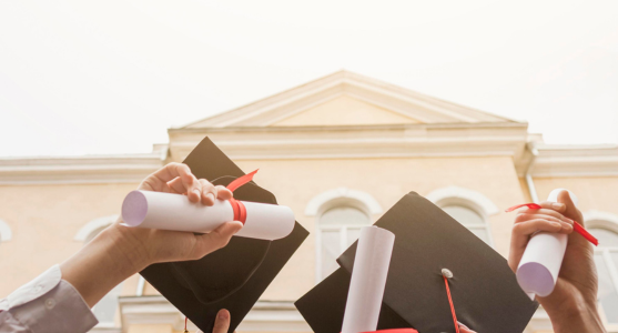 Graduation hats thrown in the air